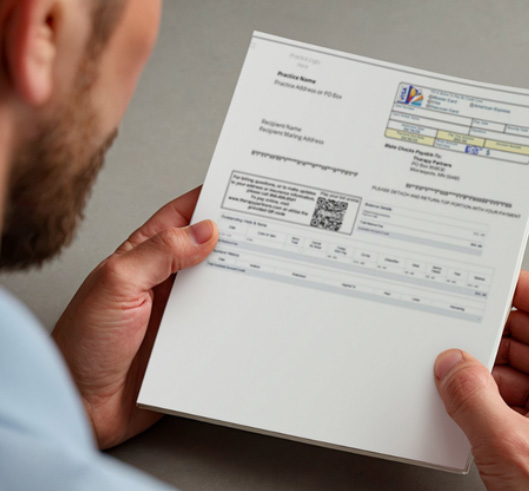 Man reviewing a printed medical billing statement.